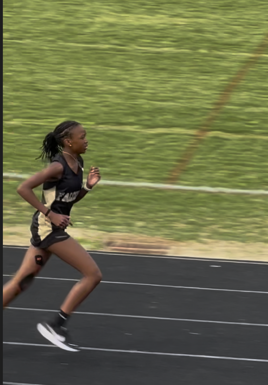 Coming through the curve at Poolesville — the sprint relay legs are my favorite part of a meet.
